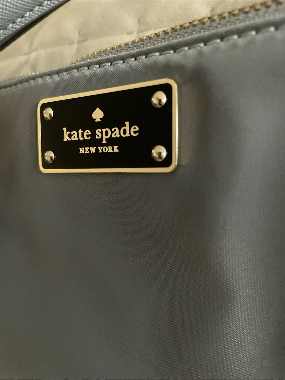 kate spade gray nylon crossbody with gold logo plaque